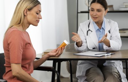 side-view-woman-holding-pills-container