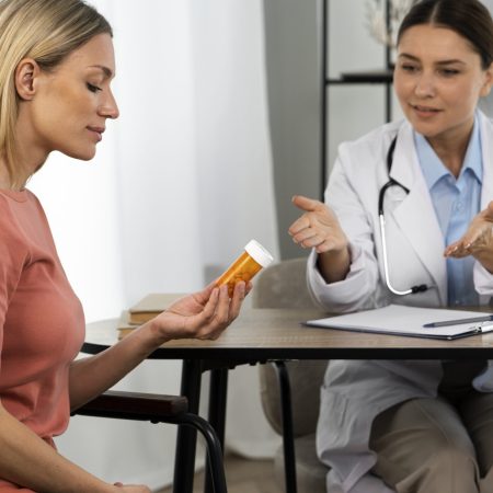 side-view-woman-holding-pills-container